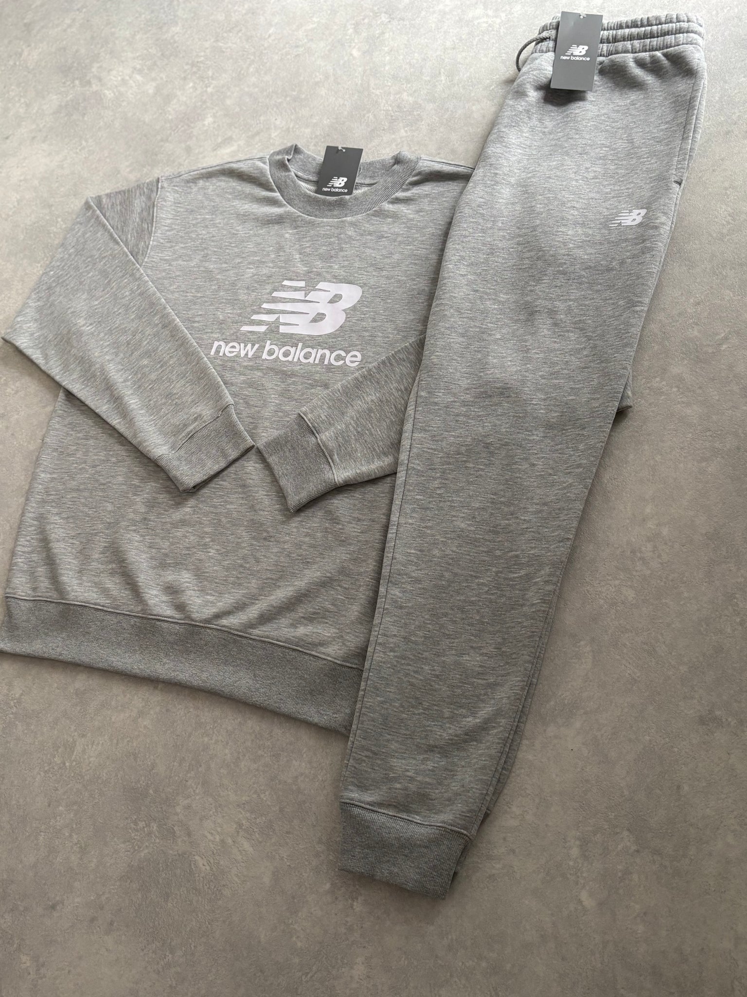 New Balance Fleece Trainingspak Grijs